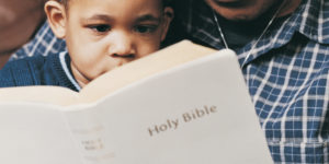 Grandfather and Grandson Reading Bible Together