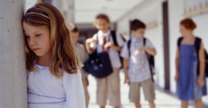 Girls standing apart from others in school --- Image by © Heide Benser/Corbis